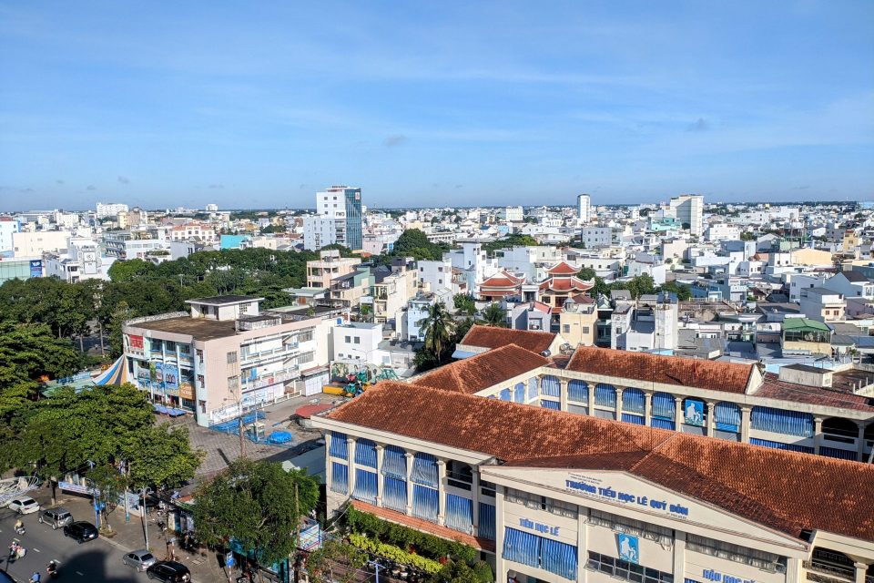 Aerial view of Cần Thơ city showcasing urban landscape and architecture under clear sky.