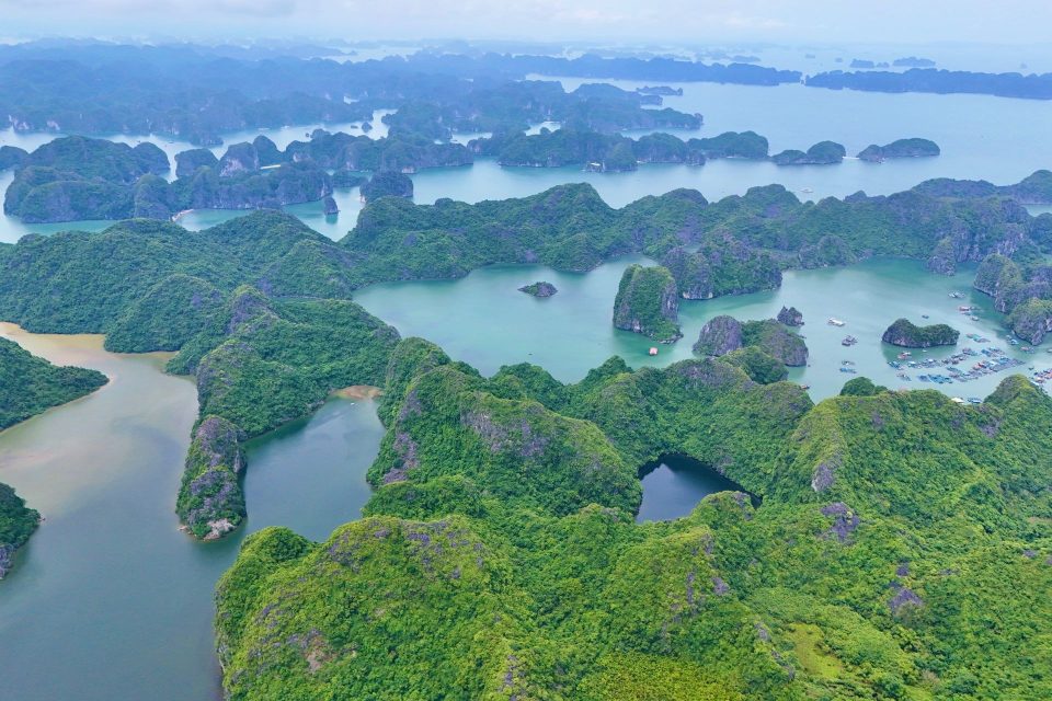 Stunning aerial shot of Ha Long Bay's lush green islands and tranquil waters in Vietnam.