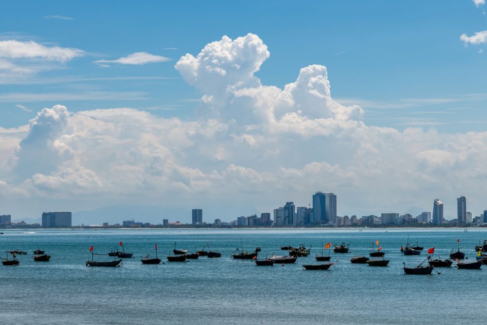 Beautiful view of Da Nang cityscape with boats in the foreground on a sunny day.