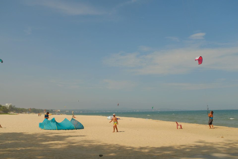 Kitesurfers enjoying a sunny day on Binh Thuan beach, Vietnam.
