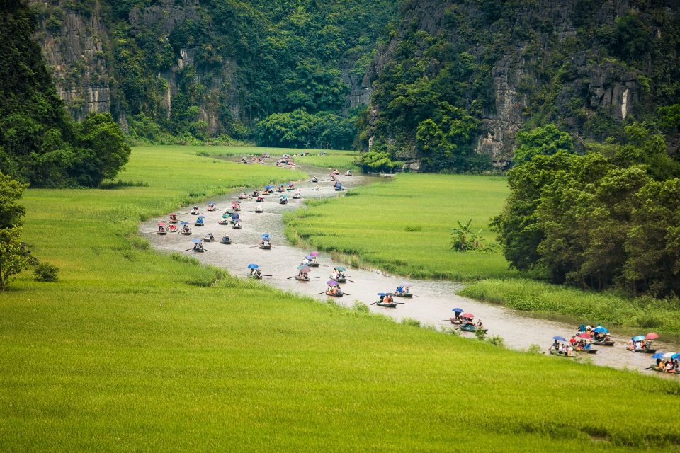 Explore scenic river and lush greenery on a boat tour in Ninh Bình, Vietnam.