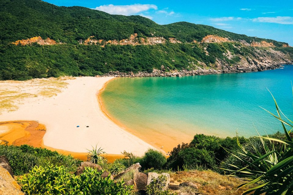 Stunning coastal view of a sandy beach and turquoise waters in Hòa Xuân, Đắk Lắk.