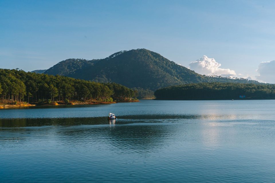 Peaceful scene of Tuyen Lam Lake with mountains and forest in Da Lat, Vietnam.