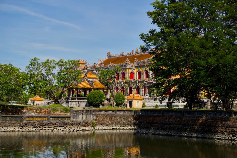A beautiful Vietnamese temple with intricate architecture reflected in a serene pond.