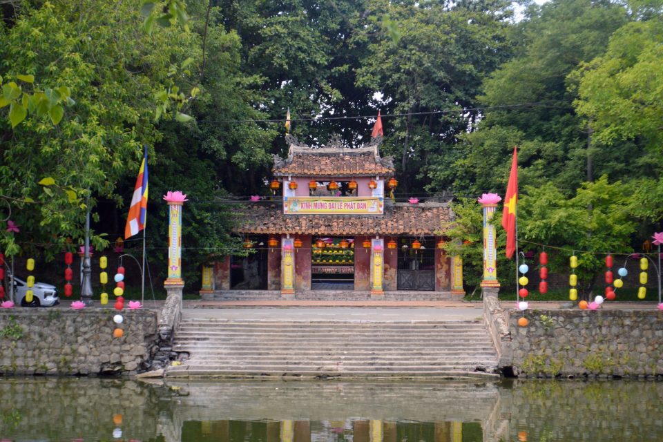 Scenic view of a Vietnamese temple adorned with colorful lanterns, reflecting cultural celebration.